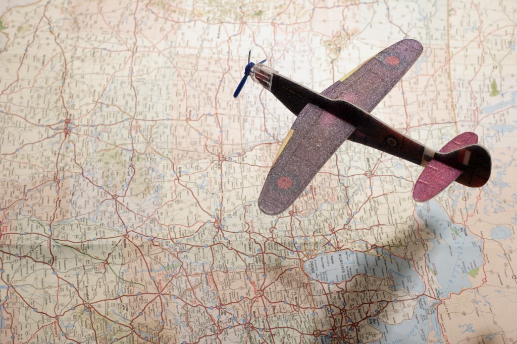 Model Airplane Over Map with Shadow